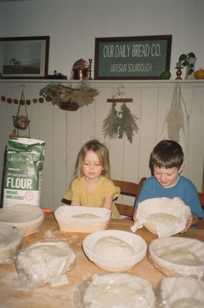 children in the kitchen looking at sourdough on the counter