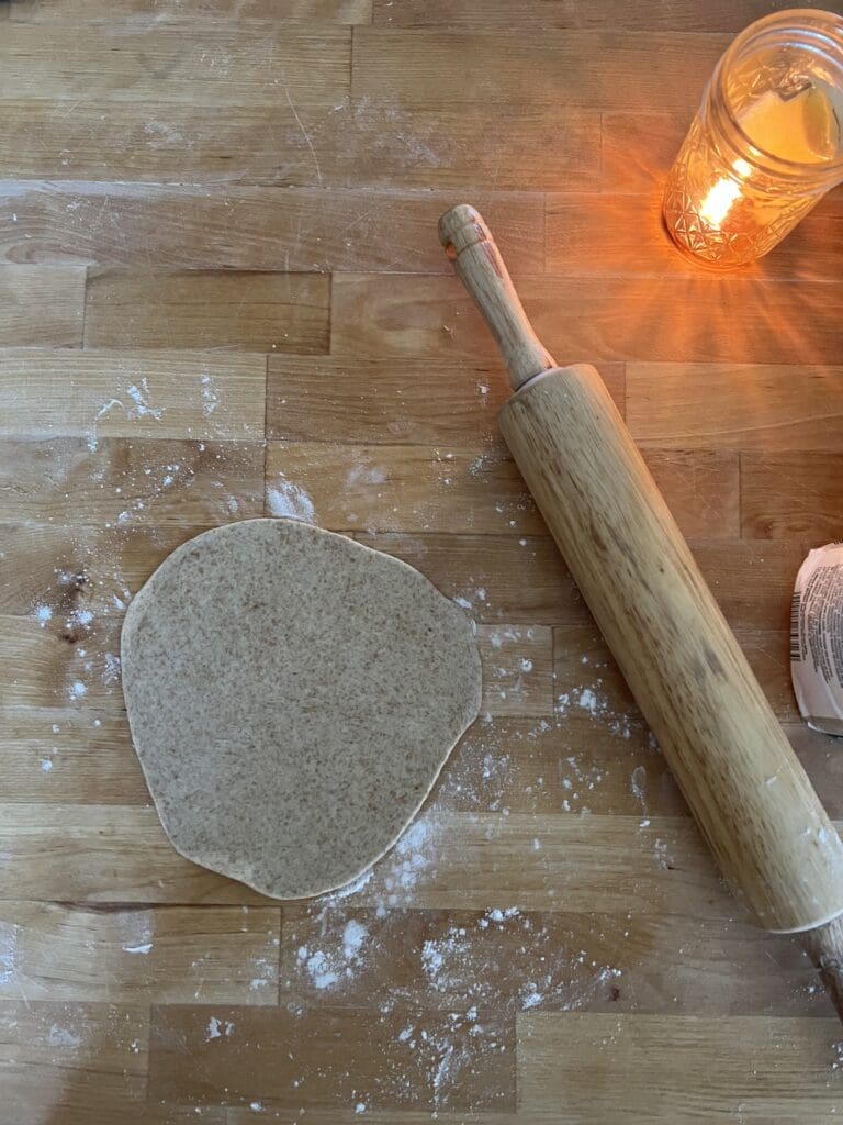 rolling pin and sourdough tortilla sitting on counter